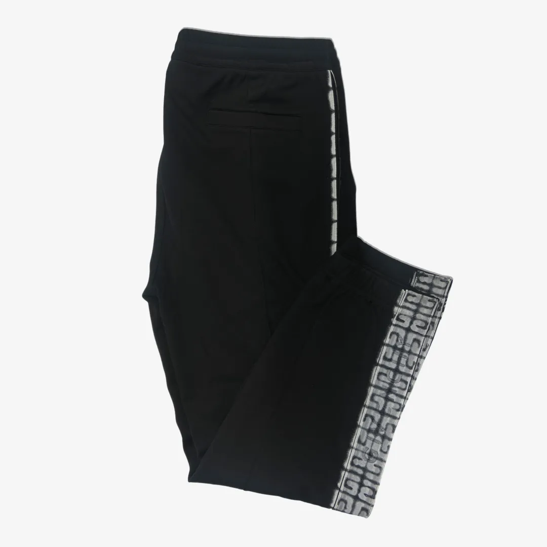 Givenchy men's black tracksuit pants with white graffiti monogram print